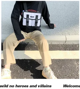 Close-up of tactical chest bag with dual buckle pockets and nylon texture on model