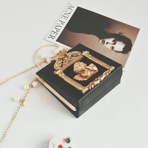 Vintage black box bag with golden angel relief and pearl chain strap for women