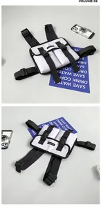 Detail of minimalist black and white tactical chest rig with adjustable nylon straps