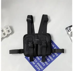 Detail of multi-functional black tactical chest bag with dual buckle pockets and nylon texture