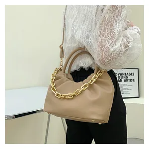 Detail of khaki pleated cloud bag with chunky gold chain strap and smooth PU leather finish