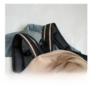 Close-up of padded breathable mesh shoulder straps on a casual minimalist backpack
