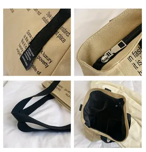 Détail du sac fourre-tout en toile kaki avec fermeture éclair argentée et large bandoulière