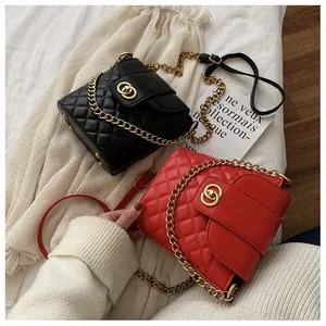 Close-up of quilted leather bucket bags with gold chain straps and metal turn-lock closures