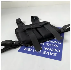 Detail of black tactical chest bag showing dual front flap pockets and buckles