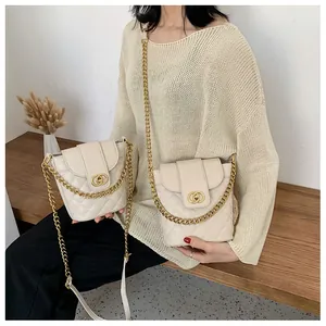 Quilted bucket bag detail showing classic diamond stitching and elegant gold chain strap