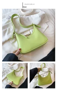 Detail view of a green crescent PU shoulder bag with adjustable strap and stitched edges