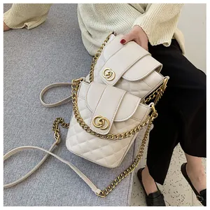 Quilted cream crossbody bag with gold chain strap and interlocking metal ring buckle