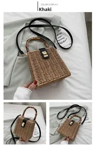 Detail of khaki woven box bag featuring bamboo handle and golden metal clasp closure