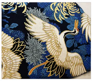 Detailed close-up of high-quality fabric featuring vintage crane and floral prints