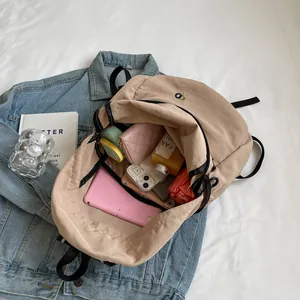 Minimalist beige waterproof backpack with large capacity storage for daily casual use
