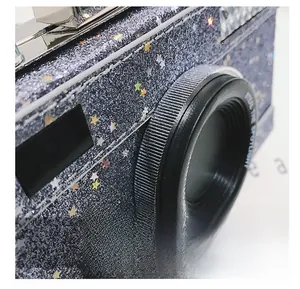Detail of glitter camera bag with colorful stars and Steal the Spotlight lens
