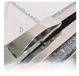 Detailed close-up of premium metal lock and glitter fabric texture on a chain bag