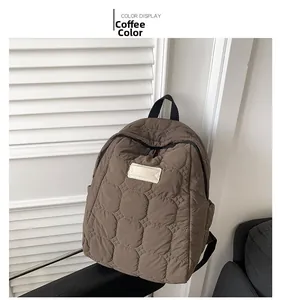 Detailed coffee brown quilted backpack with circular stitching and minimal label