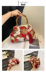 Detail of red Chinese style bag with crane embroidery, bamboo handle and long silk tassel