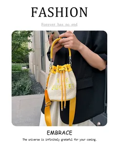 Close-up of woven bucket bag with yellow leather trim and embroidered brand text