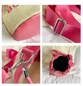 Detail of straw bucket bag featuring pink leather trim, silver hardware and embroidery