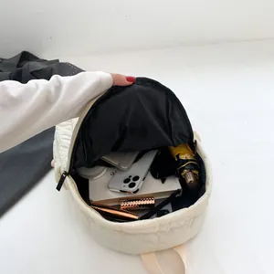 Beige quilted backpack with spacious main compartment for daily storage and essentials
