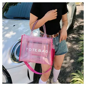 Pink translucent mesh tote bag with TOTE BAG lettering and canvas shoulder strap detail