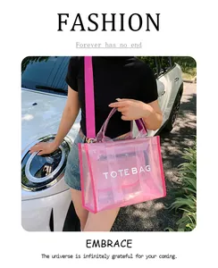 Pink transparent tote bag with letter print shown on model in outdoor setting