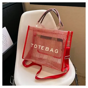 Detailed close-up of a red mesh tote bag with white TOTE BAG text on a white chair