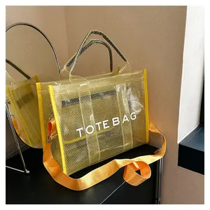 Detail of yellow transparent PVC tote bag with grid texture and orange strap