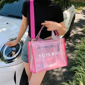 Summer pink transparent mesh tote bag with wide strap shown in an outdoor lifestyle setting