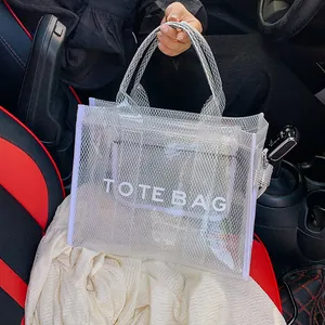 Minimalist white mesh tote bag with TOTE BAG print and inner pouch on a car seat
