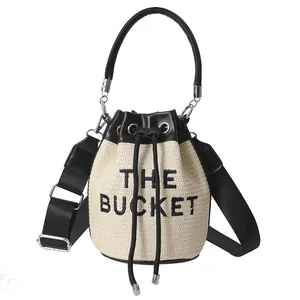 Straw bucket bag with black leather trim and embroidery for stylish women's summer fashion