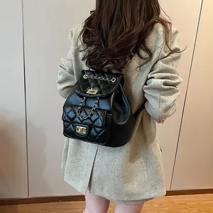 Fashionable black quilted backpack with golden chain and leather straps for women