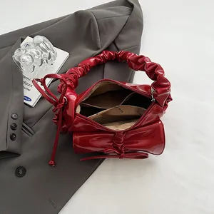 Glossy red French baguette bag with bow and ruched handle for women, trendy chic style