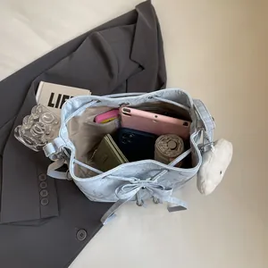 Light blue marble bucket bag with heart pendant showing spacious interior for essentials