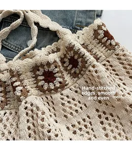 Detailed close-up of knit mesh texture and hand-stitched patchwork on crochet bag