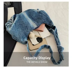 Capacity display of blue washed denim shoulder bag with phone and daily items