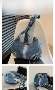 Detail of the knotted strap and faded denim texture on this blue casual shoulder bag