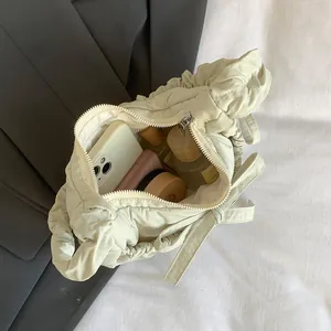 Creamy pleated quilted shoulder bag with spacious interior for cosmetics and phone