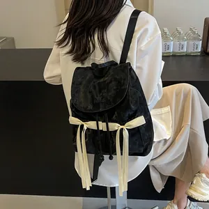 Black velvet ballet-style backpack with cream ribbons and bow decorations
