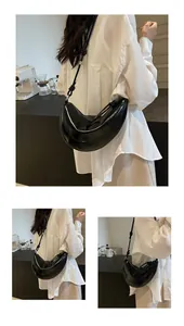 Close-up of black crescent dumpling bag with decorative knot and smooth leather texture