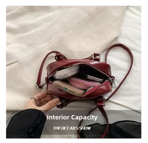 Detail view of the red PU leather handbag internal capacity with daily essentials