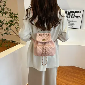 Chic pink quilted mini backpack with metal chain straps and classic turn-lock closure