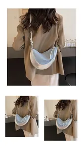 Detail of crescent canvas bag featuring silver leather trim and rope knot shoulder strap