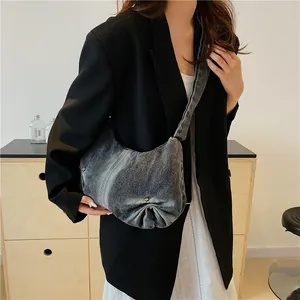 Chic pleated grey denim shoulder bag with vintage wash and crescent moon silhouette