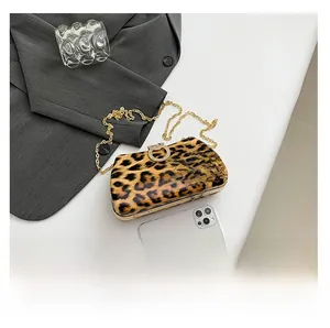Detailed comparison showing leopard print evening bag size with a smartphone and gold chain