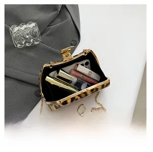 Interior view showing the capacity of leopard print evening bag with golden chain