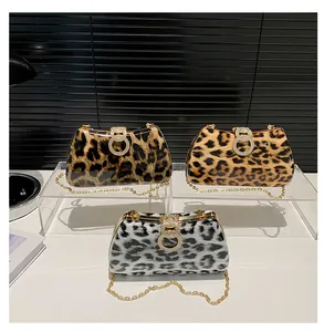 Detailed view of leopard print party clutches with gold metal frames and chain straps