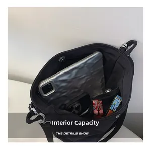 Detail view of the black tote bag showing spacious internal capacity and magnetic closure