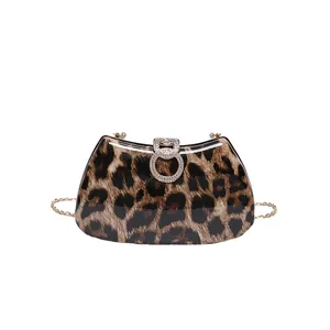 Macro view of leopard print evening bag with rhinestone double ring clasp and chain