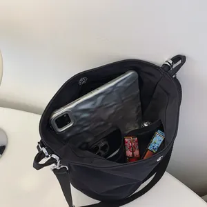 Chic black nylon bucket bag with spacious interior for tablet and cosmetics