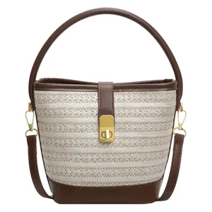 Rainbow woven bucket bag in cream with dark brown leather handles and gold clasp