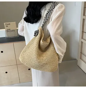 Hobo straw bag with zebra pattern strap and hand-woven texture for summer style